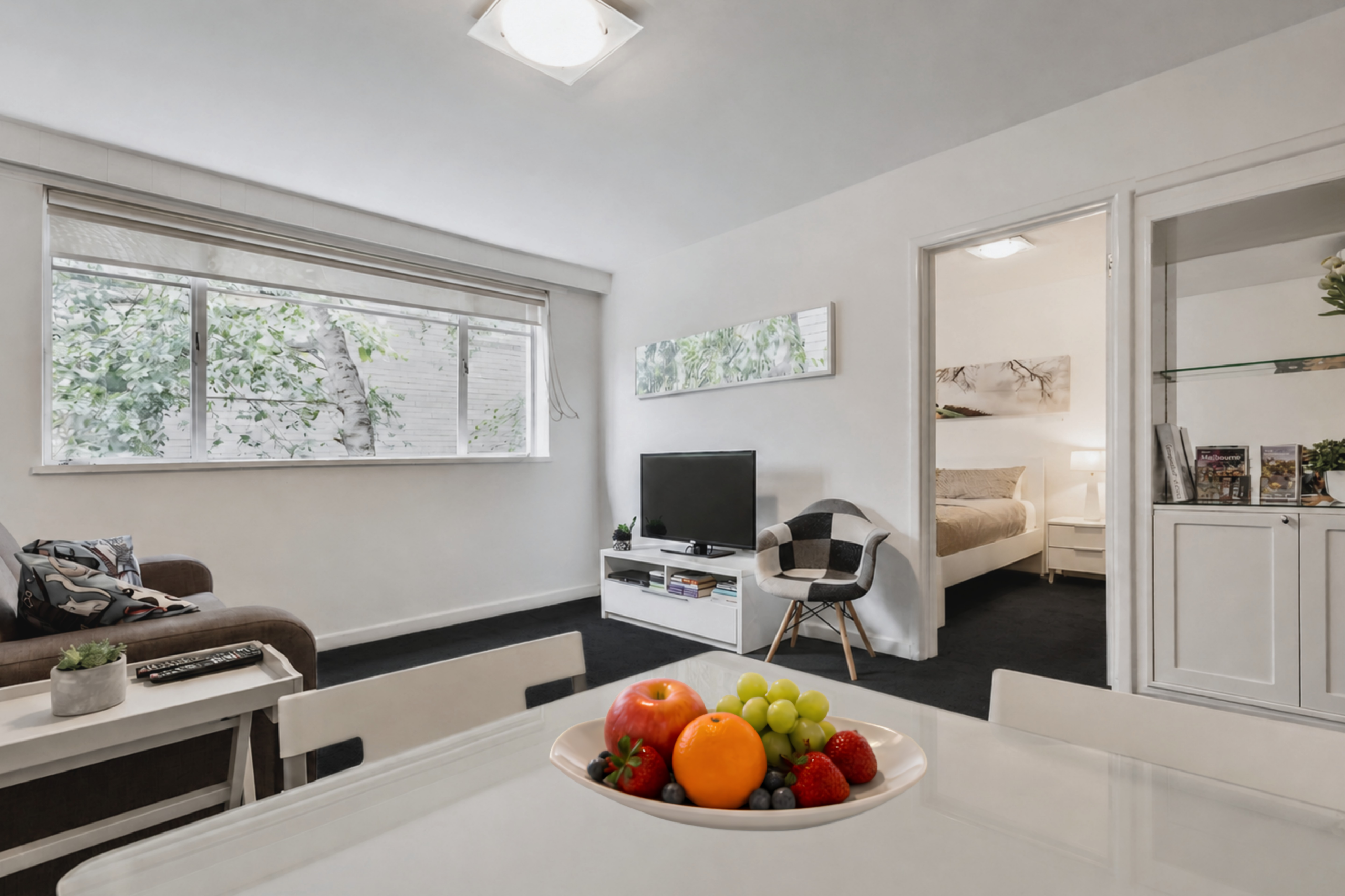 Fully furnished apartment in South Yarra with dining area, lounge and fresh fruit