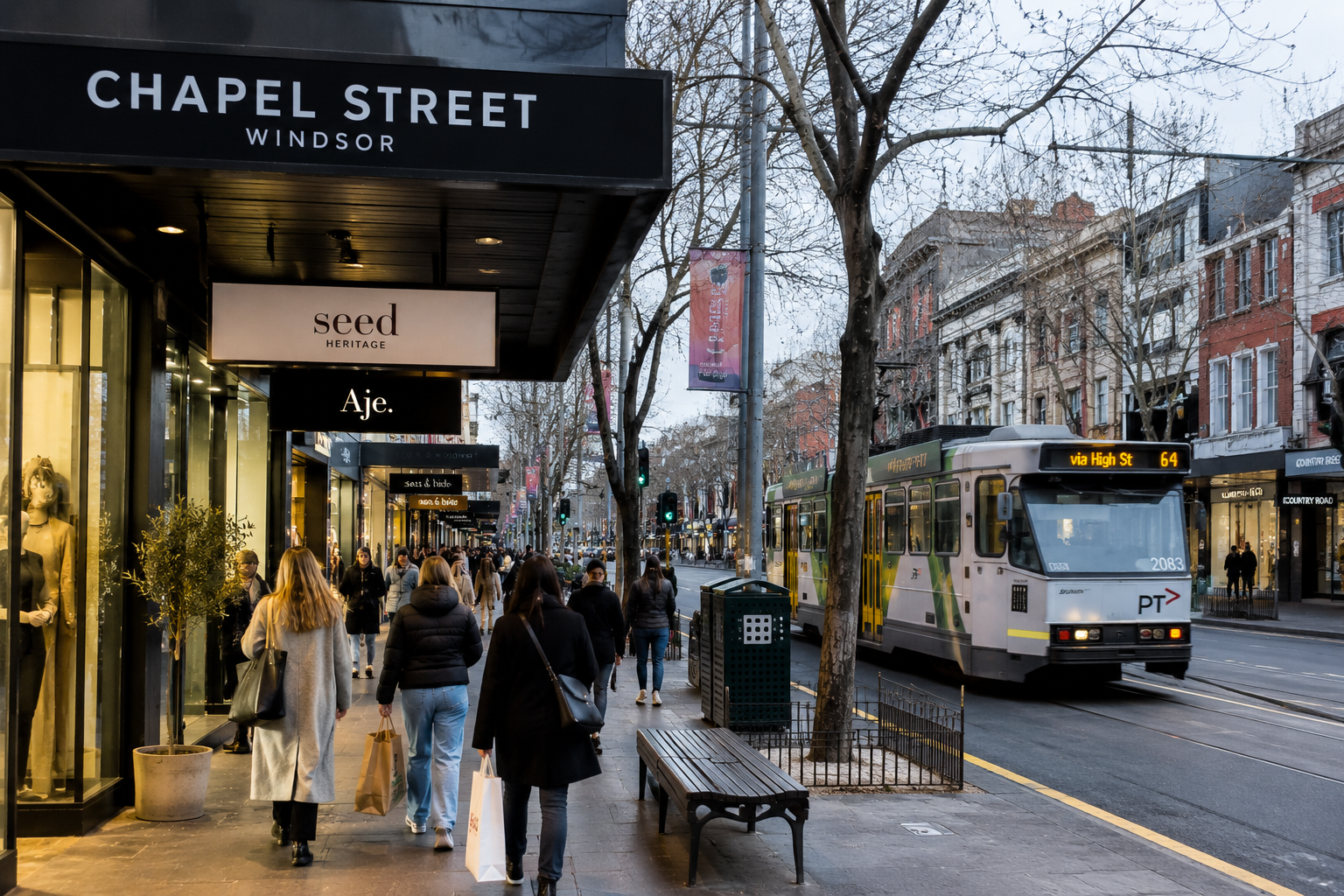 Shoppers enjoying winter shopping along Chapel Street in South Yarra with fashion boutiques and a Melbourne tram.